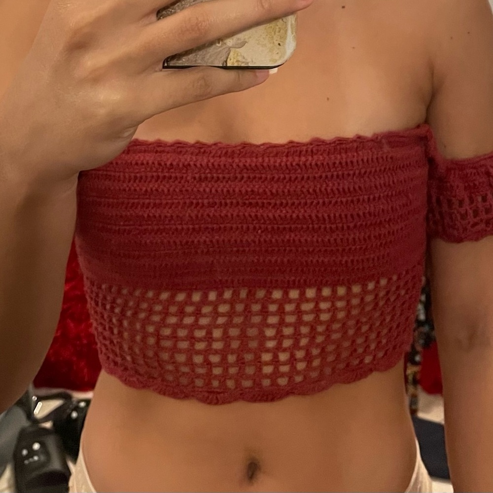 Andi boutique in a ruby color deep red, crop sleeveless but has little sleeves